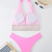 Détail de la bande graphique sous la poitrine du bikini, avec motif zigzag coloré.